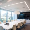 recessed white lighting in white themed meeting room